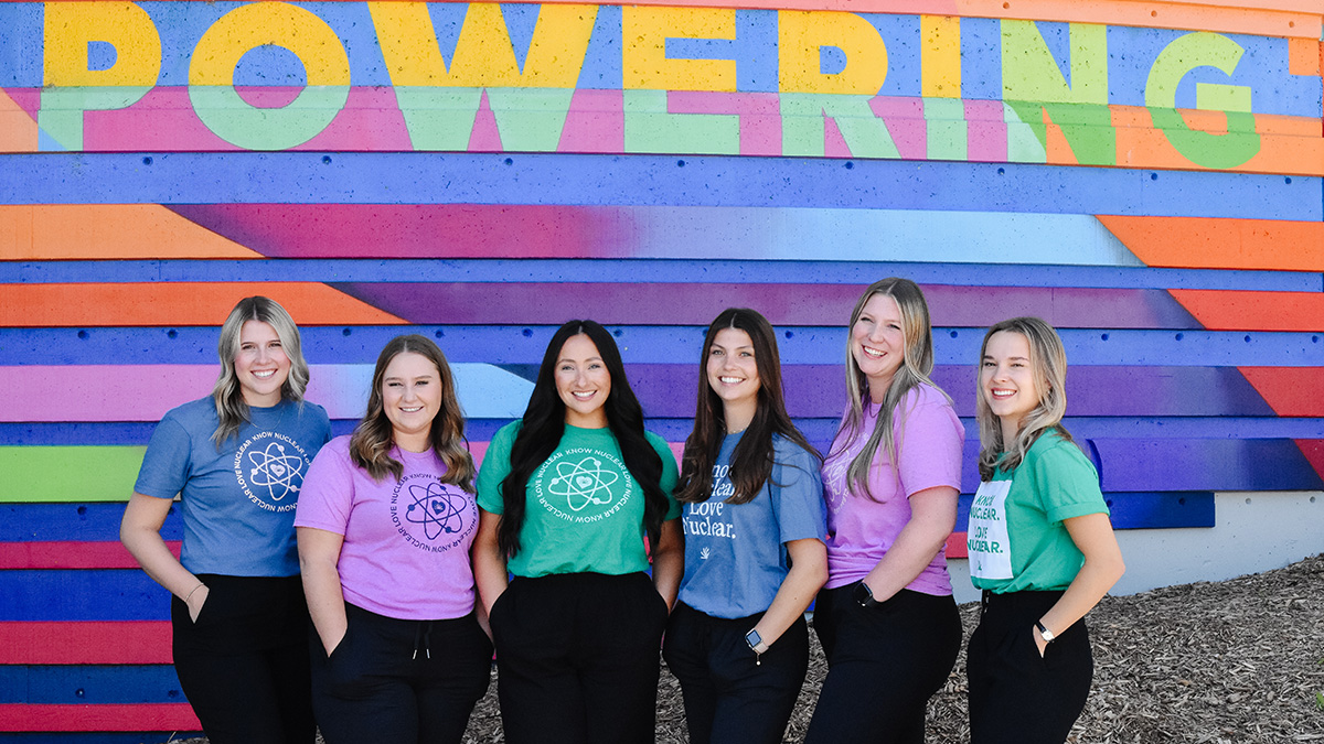 Bruce Power Corporate Social Responsibility fund. Group of six female students in front of ‘Powering’ sign.
